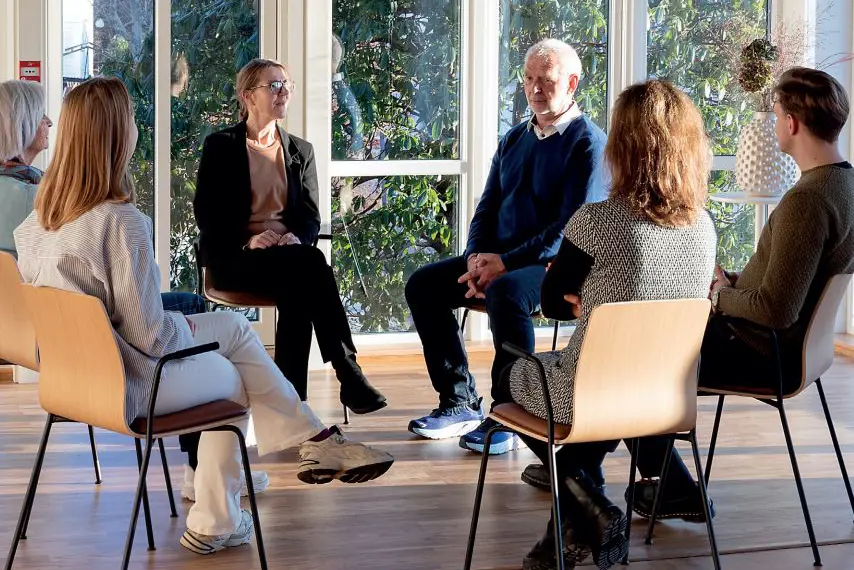 En gruppe mennesker som sitter i stoler