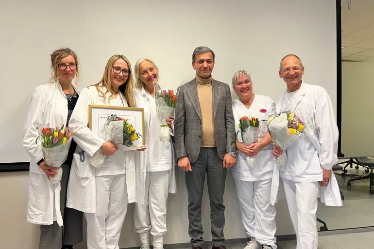 En gruppe mennesker som holder blomster