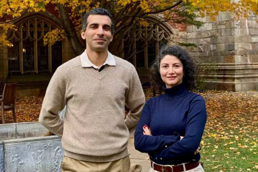 A man and woman standing together outside