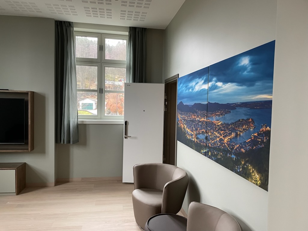 Et rom med stor skjerm og stoler