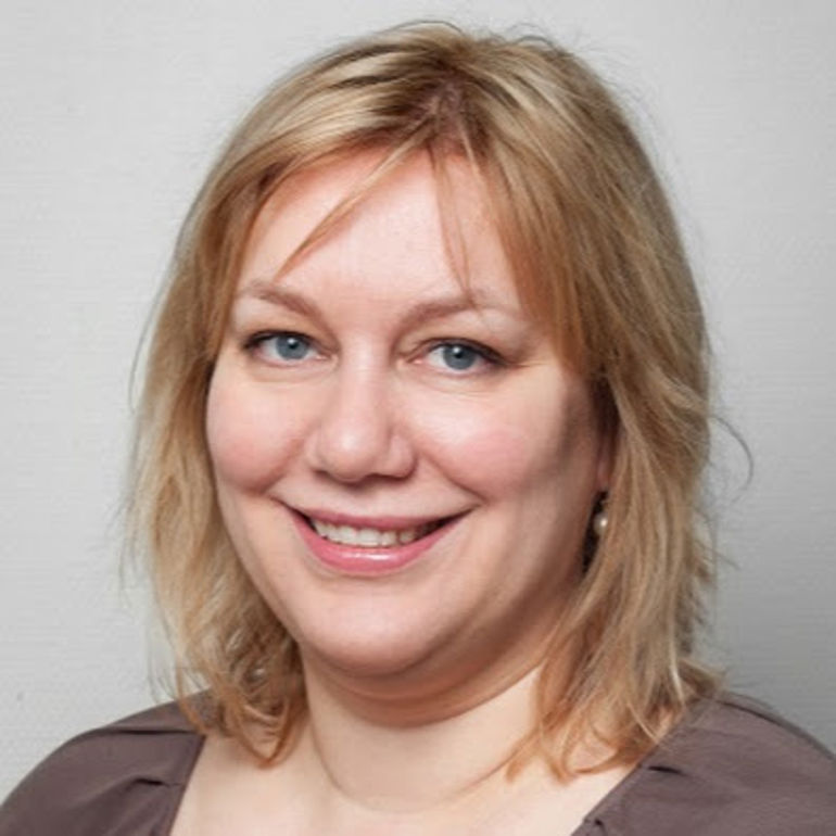 A close-up of a woman smiling