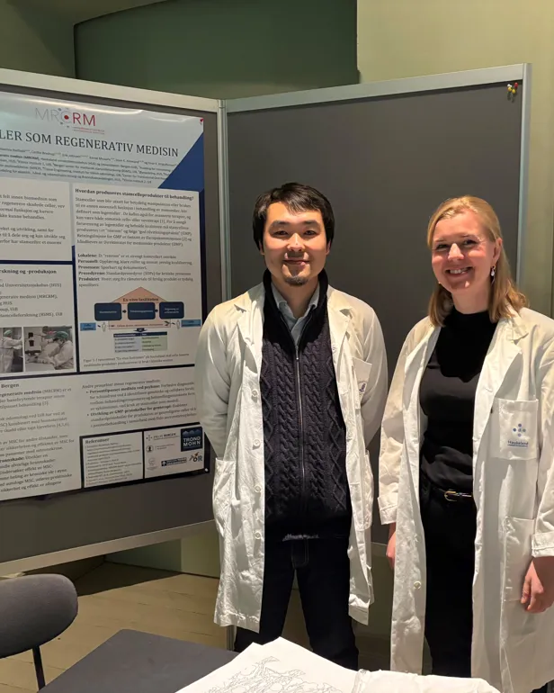 A man and a woman standing next to a poster