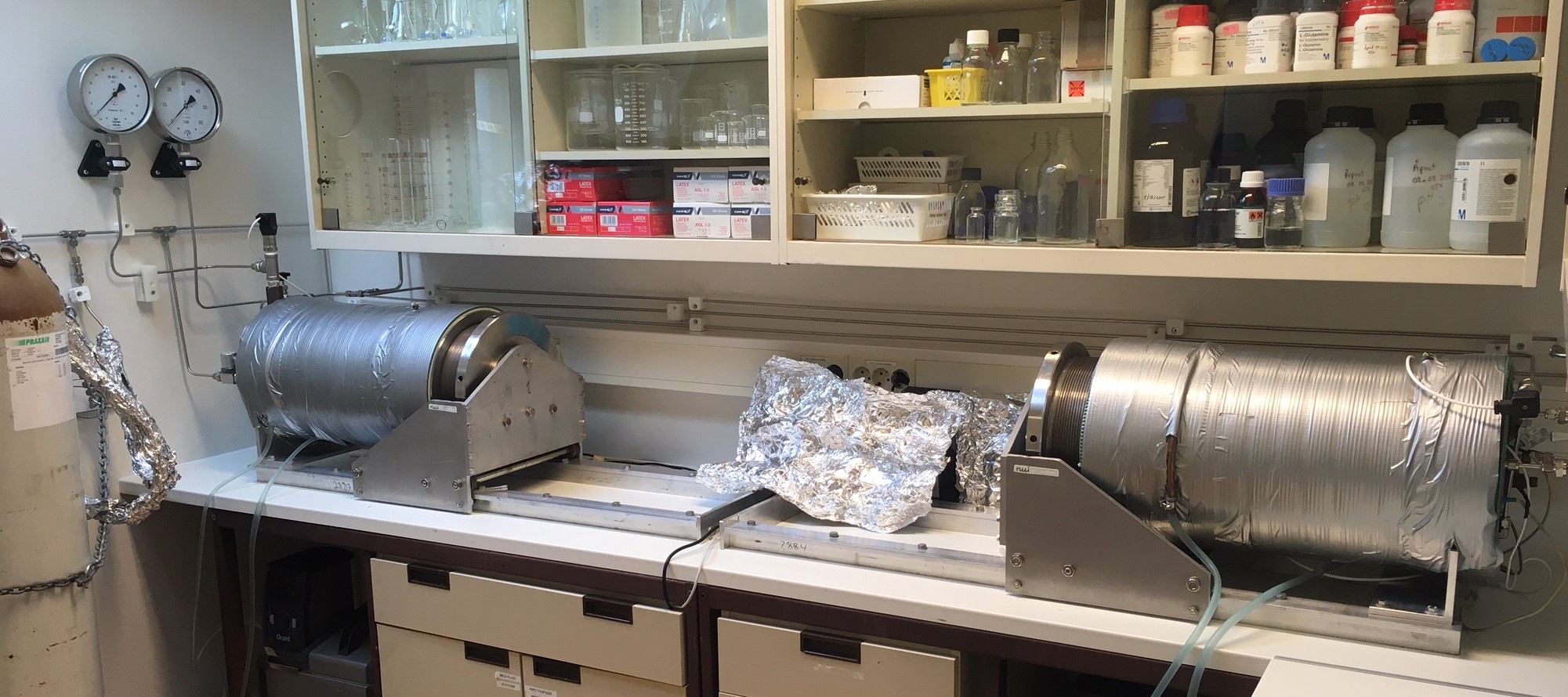 A kitchen counter with a large metal pot on top