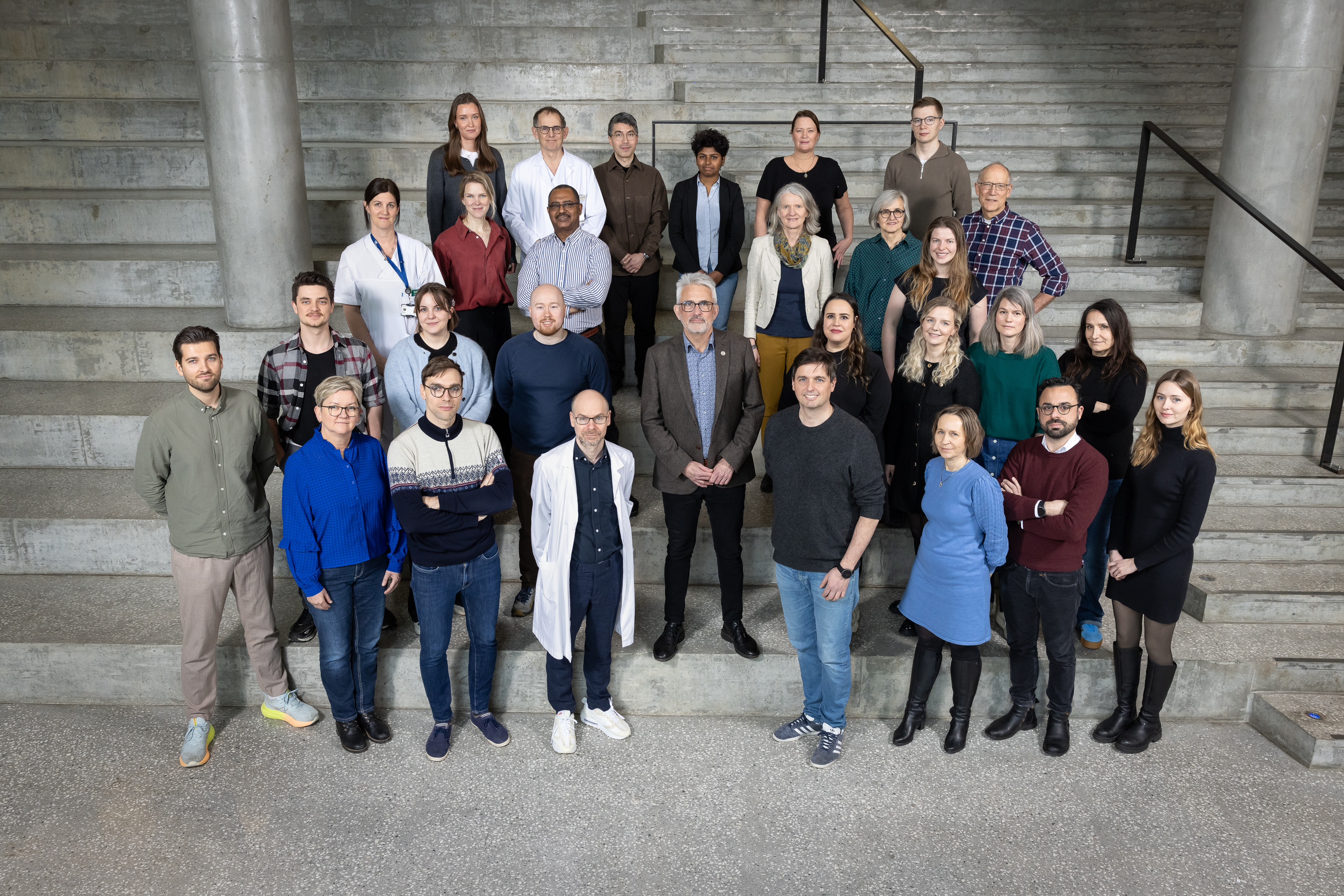 A group of people posing for a photo on stairs
