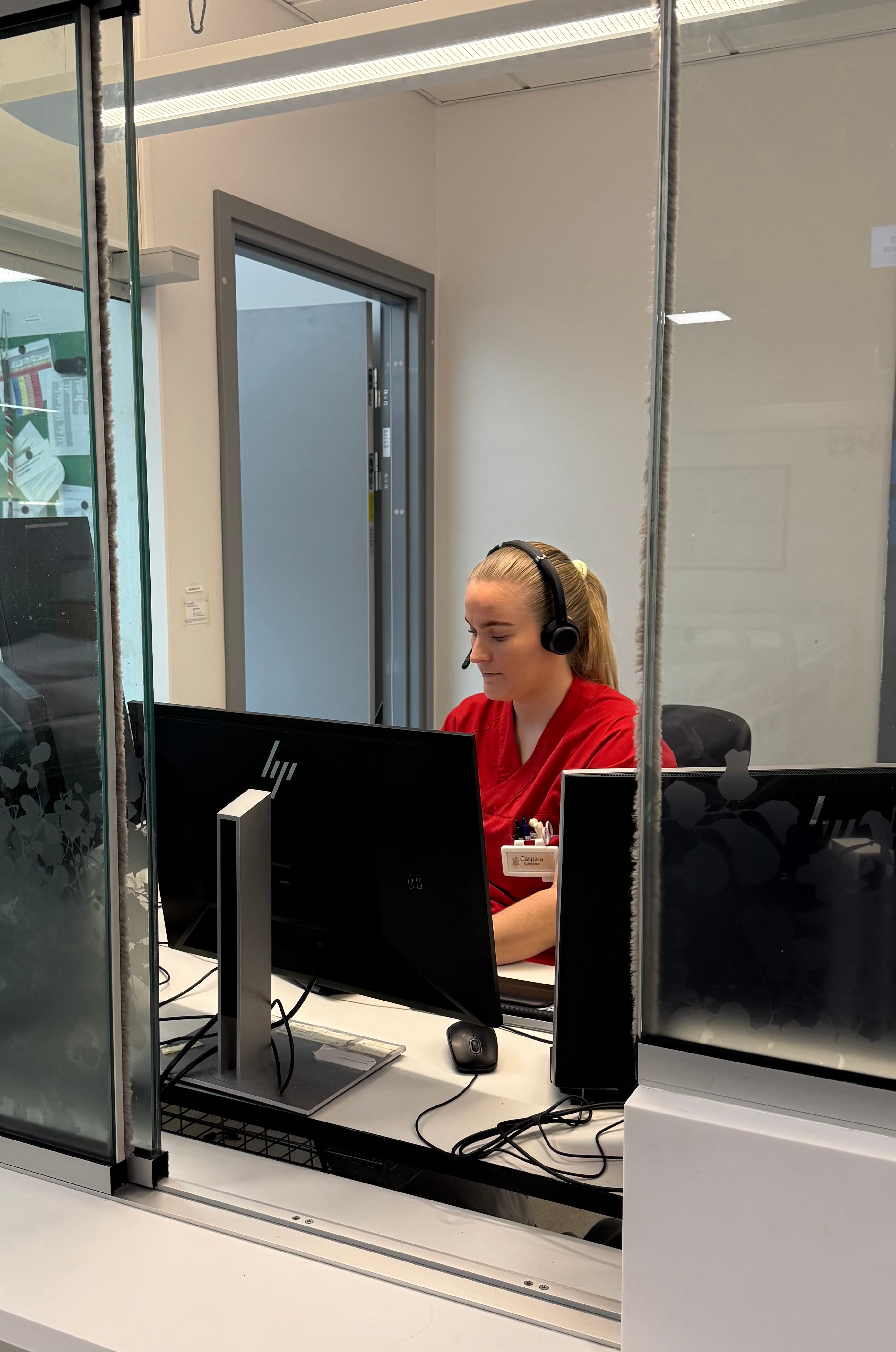 A person wearing headphones and sitting at a computer