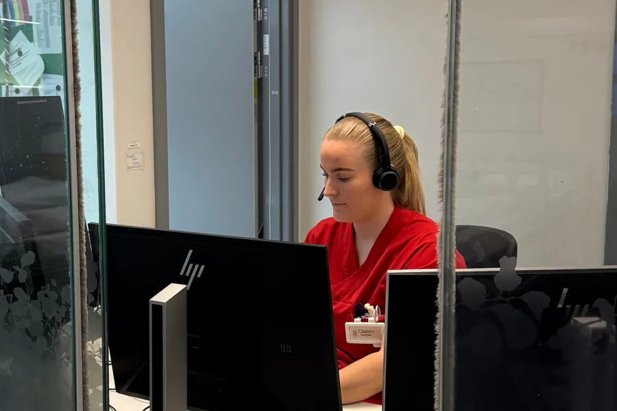 A person wearing headphones and sitting at a computer
