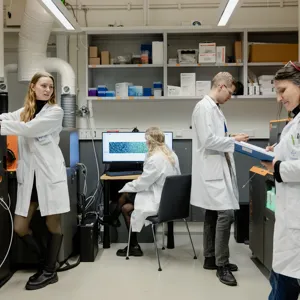 En gruppe mennesker i laboratoriefrakker