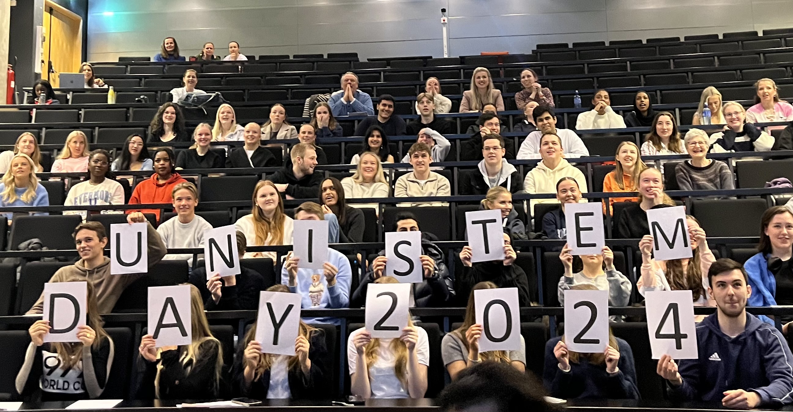 A group of people holding signs