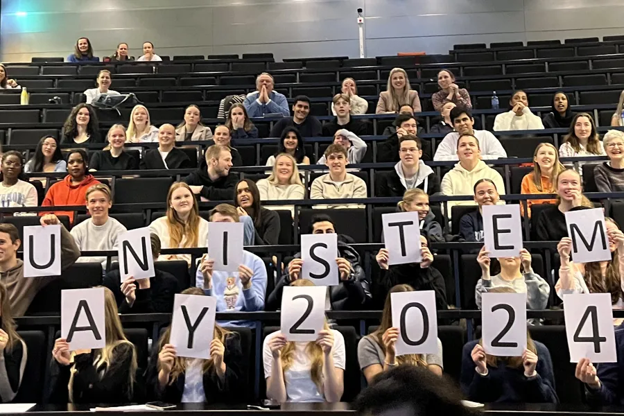 A group of people holding signs