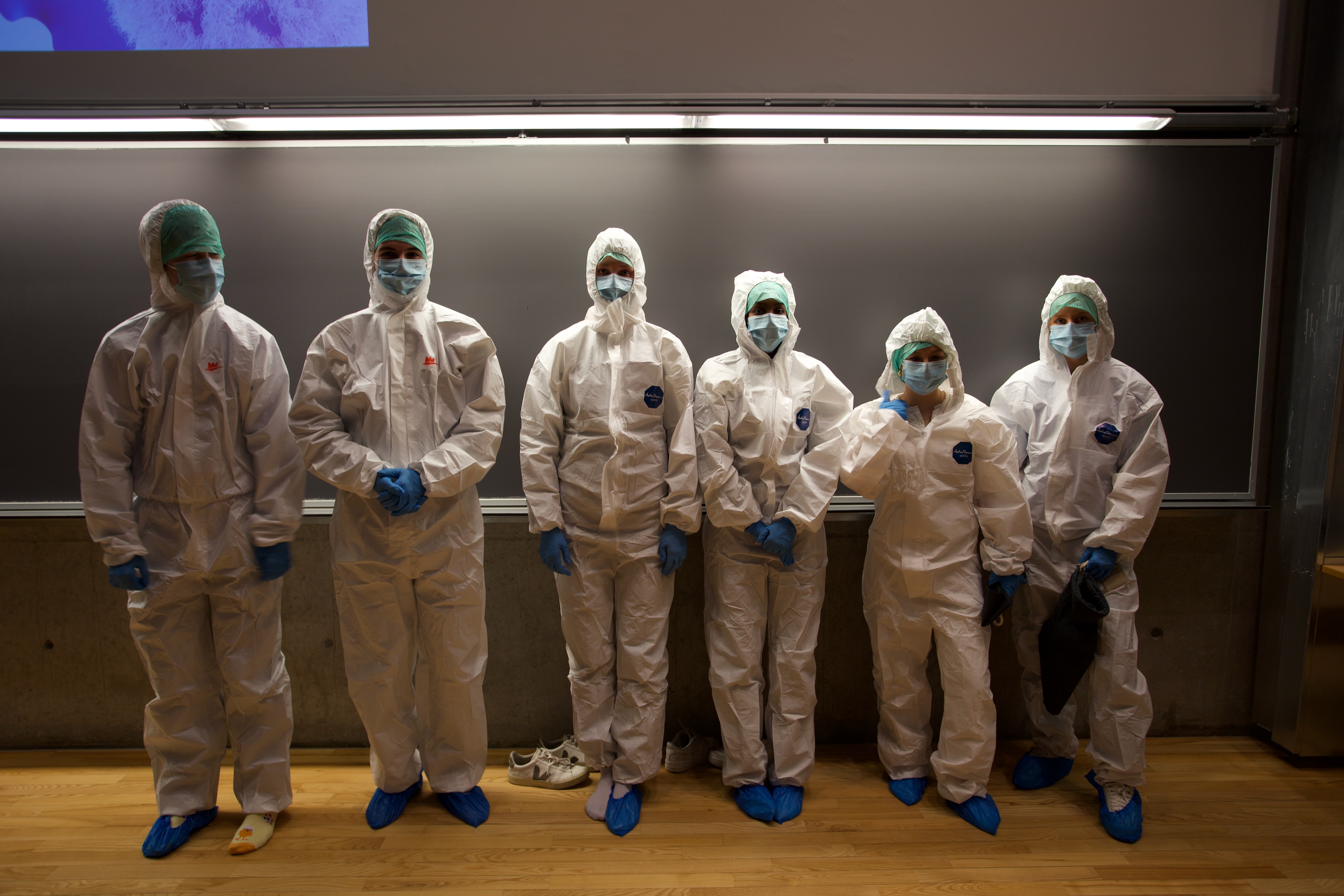 A group of people wearing white masks