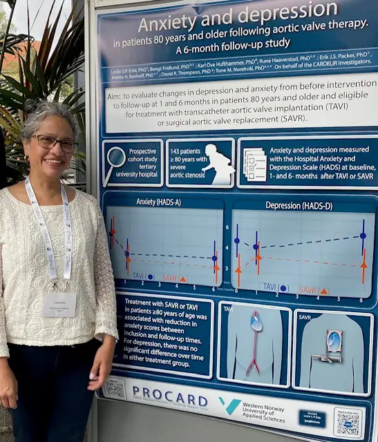 A woman standing next to a poster with information about a study