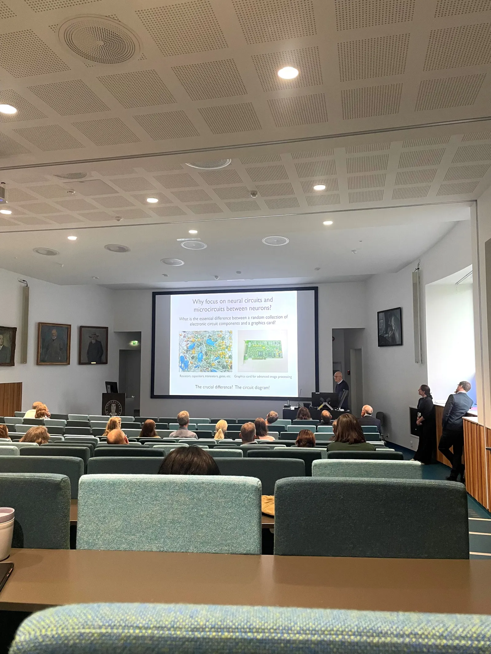 A group of people in a room with a projector screen