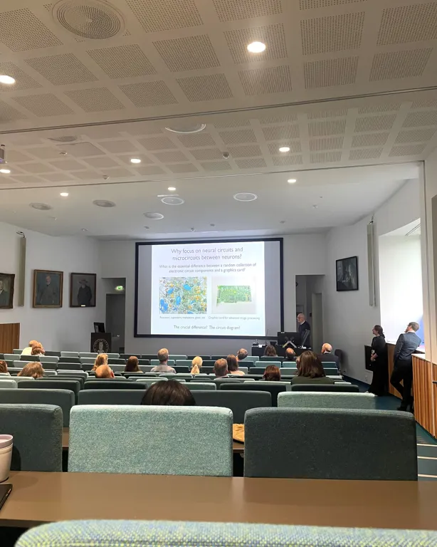 A group of people in a room with a projector screen