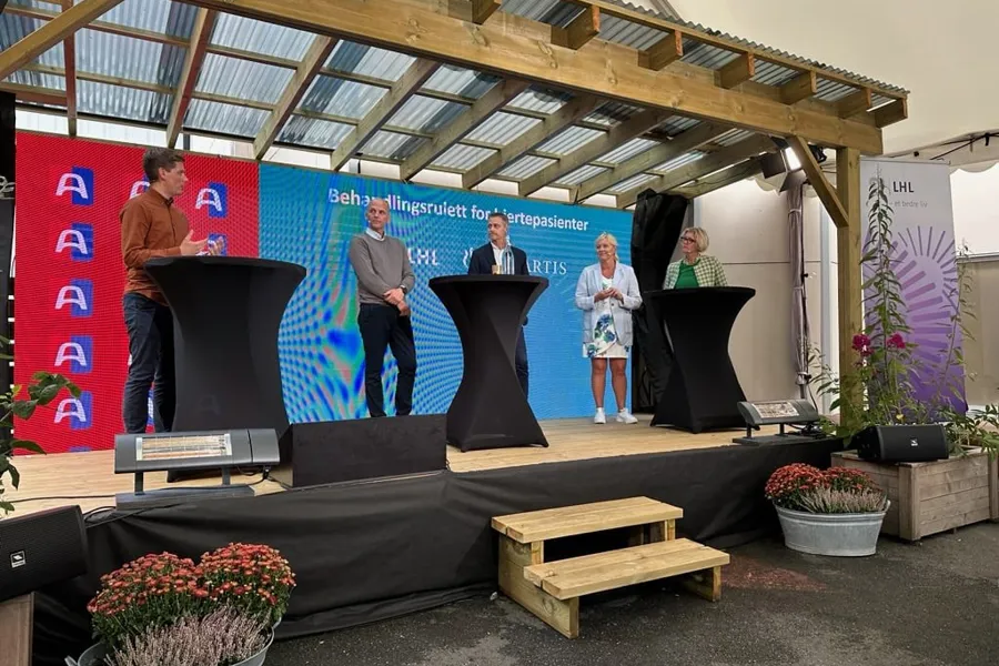 A group of people on a stage talking to each other