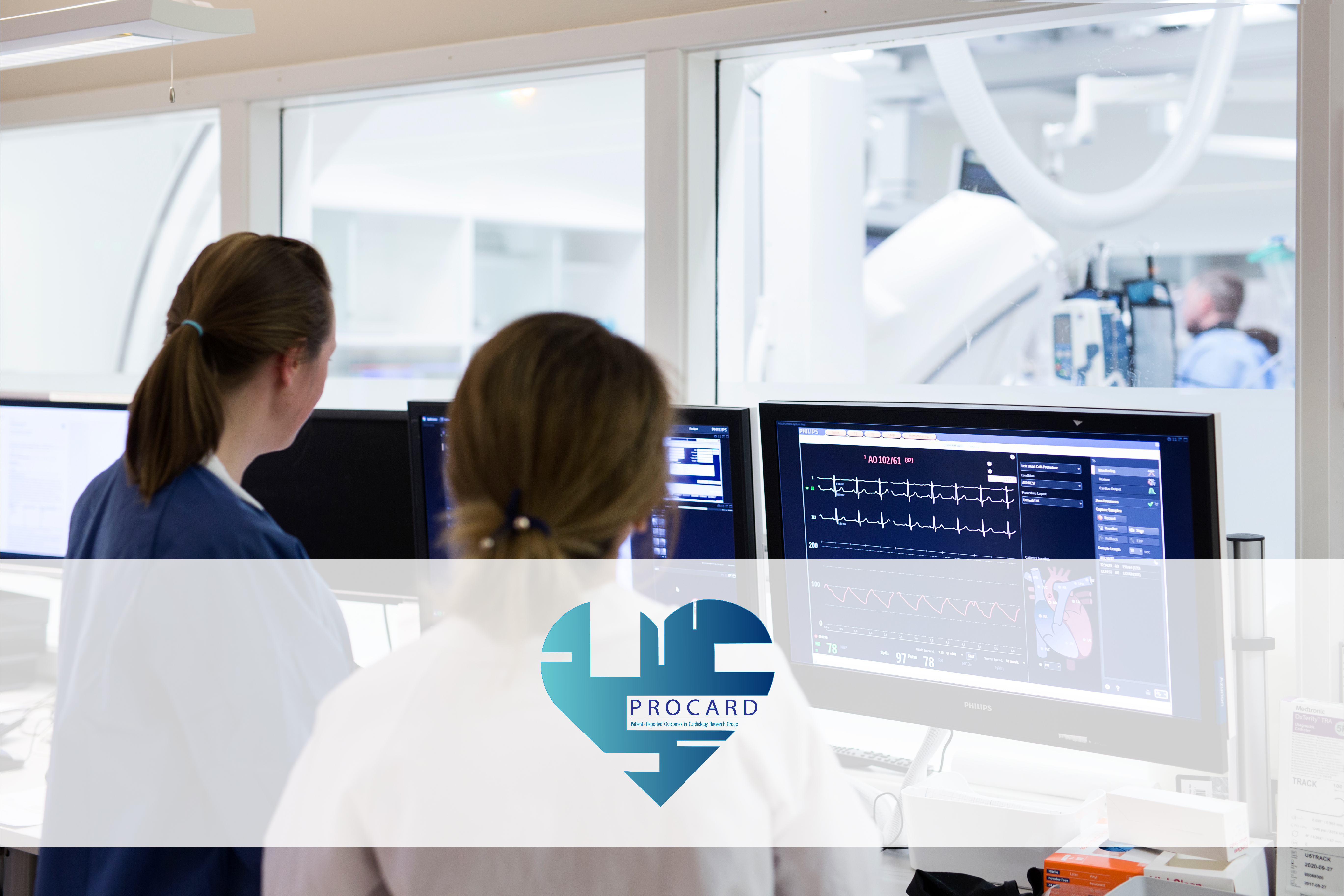 Two persons watching a screen