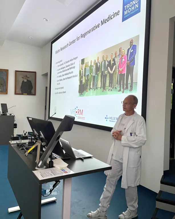 A person standing in front of a large screen