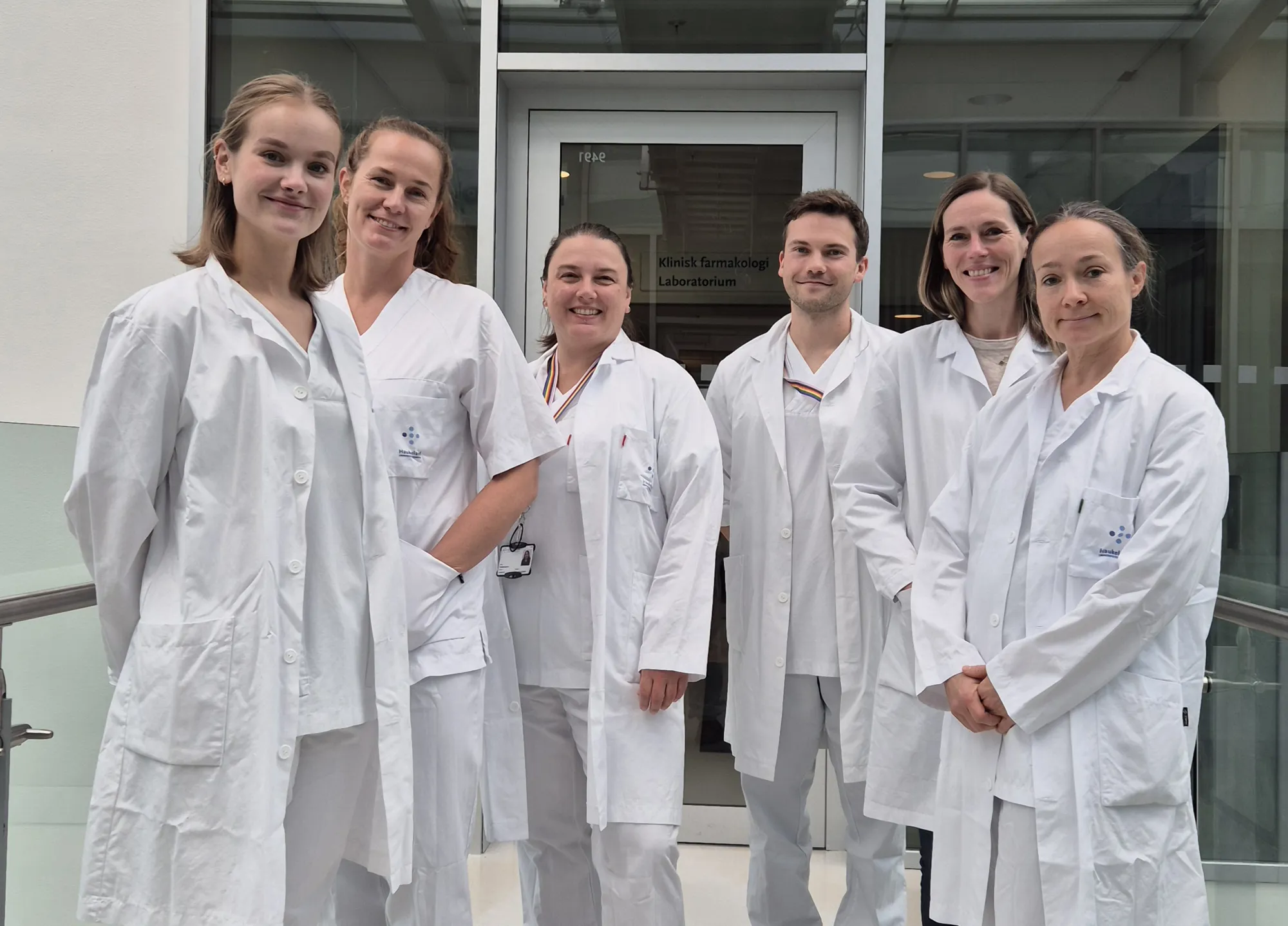 A group of people wearing white lab coats