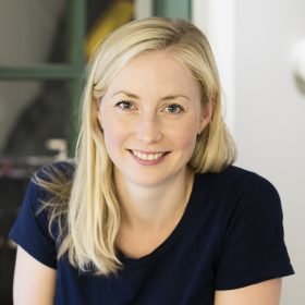 En kvinne som smiler til kameraet