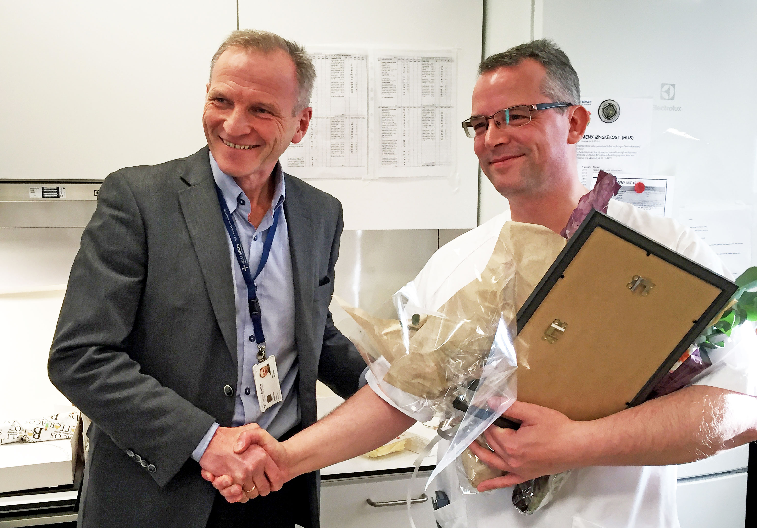 Eivind Hansen gratulerer årets helsearbeider. Foto