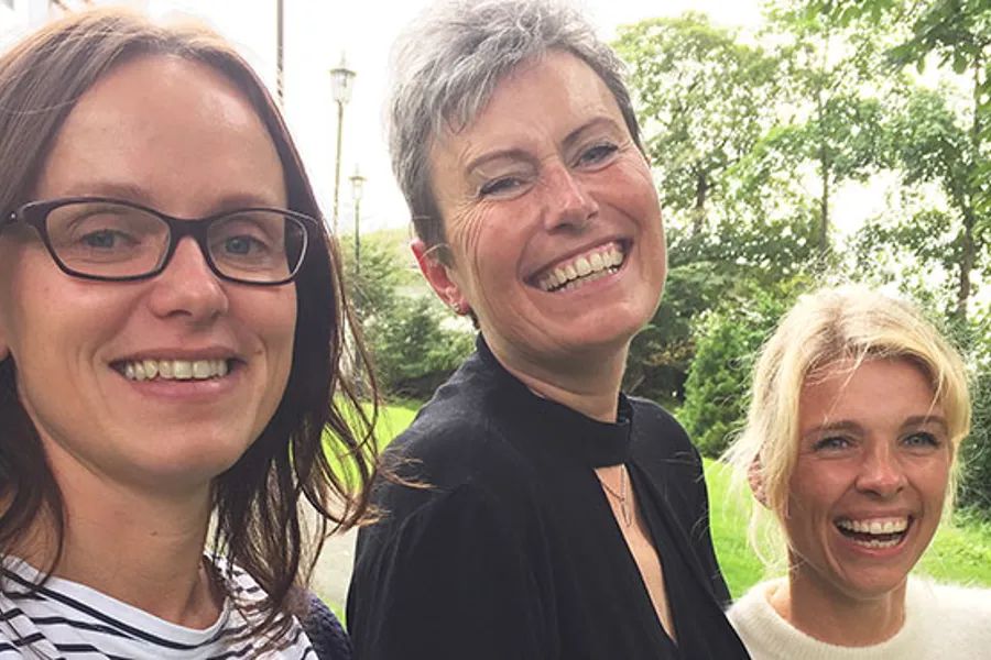 En gruppe mennesker som smiler