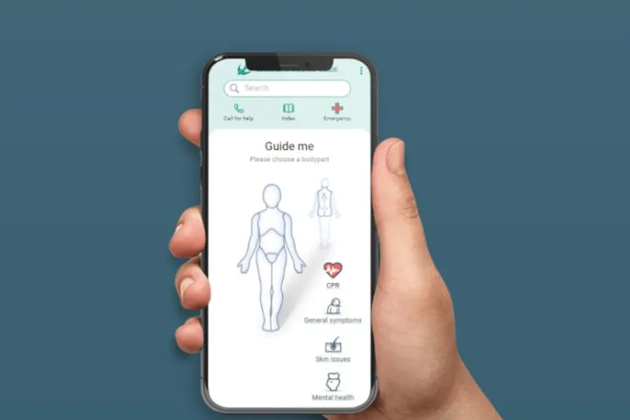 Hand holding mobile while demonstrating the mariners medico guide app on the screen. Photo.