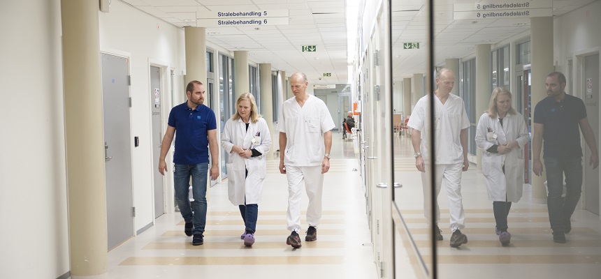 A group of people walking through a hallway