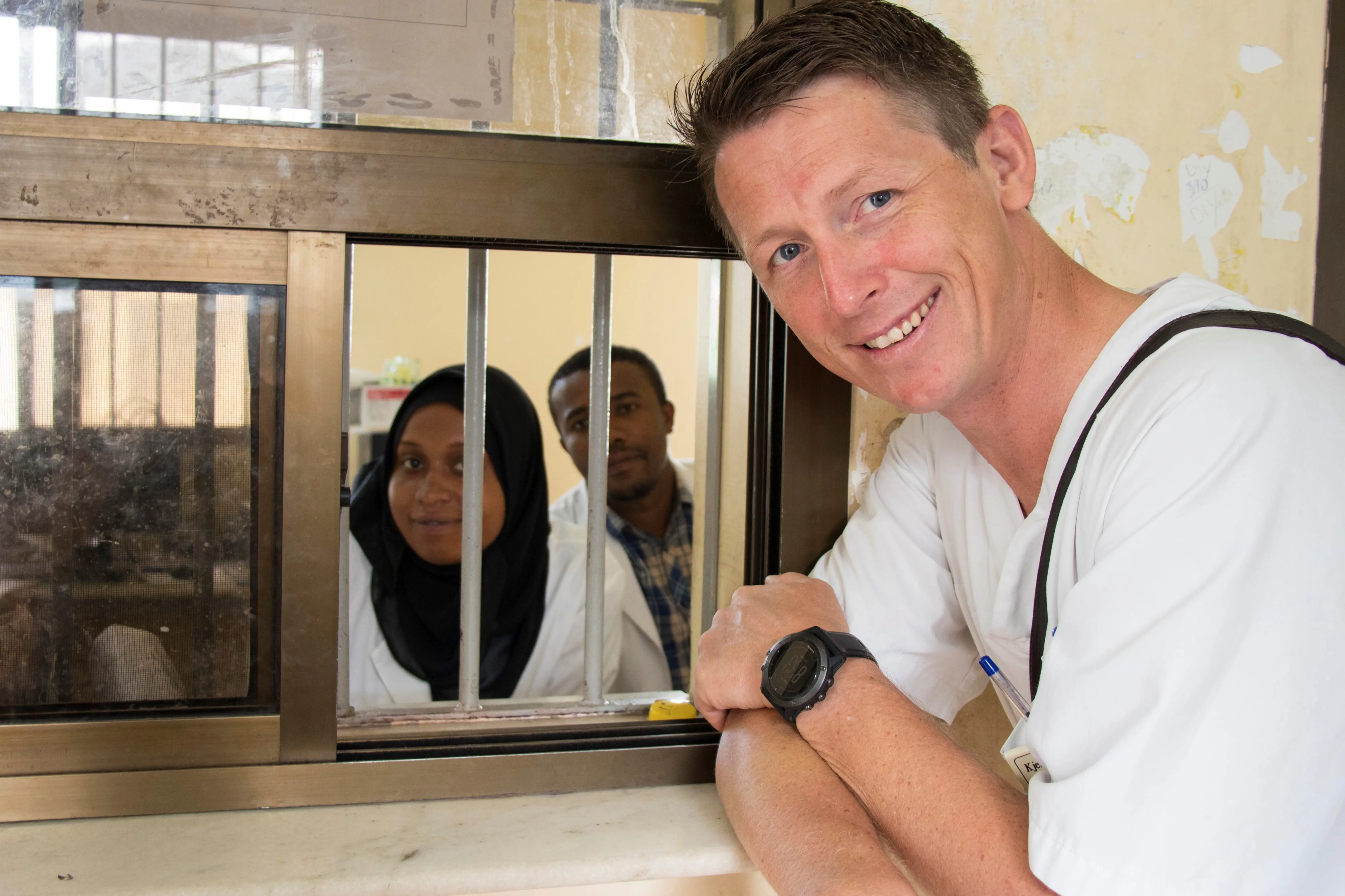 sykepleier står foran luka og snakker med ansatte