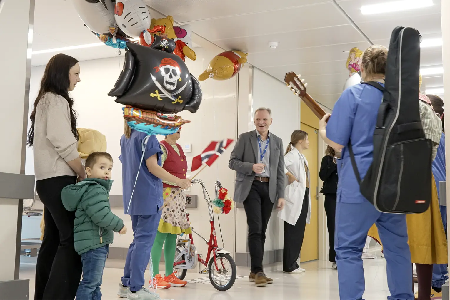 Flere barn og voksne går i tog med ballongen