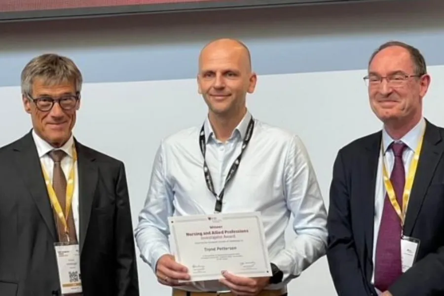 A few men holding a certificate
