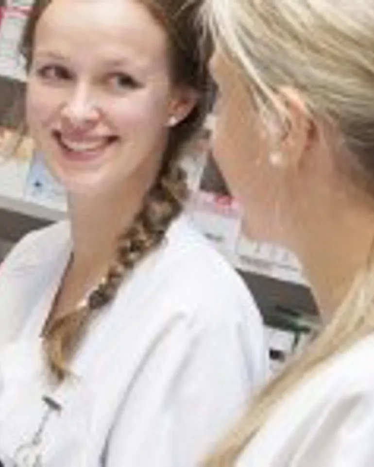 A woman looking at another woman