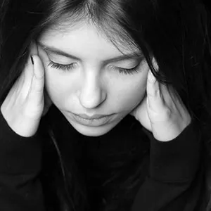 En kvinne med hånden i ansiktet