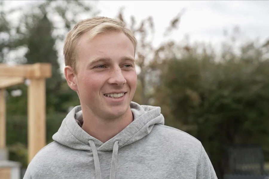 En ung mann som smiler til kameraet