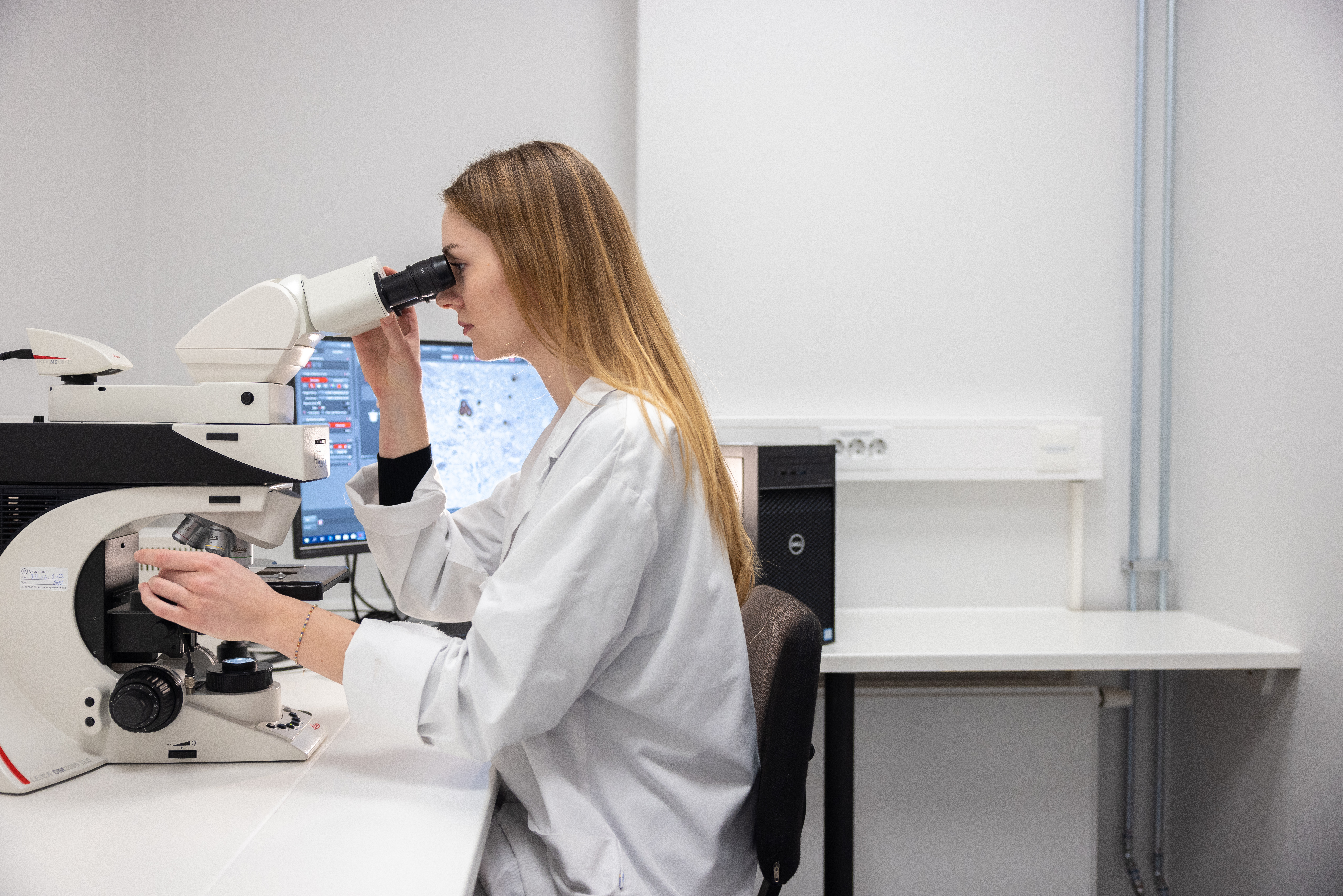 Researcher looking in a microscope