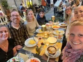 A group of people sitting at a table with food