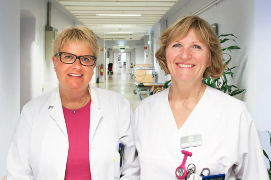 To smilande kvinnelege tilsette i sjukehuskorridor.